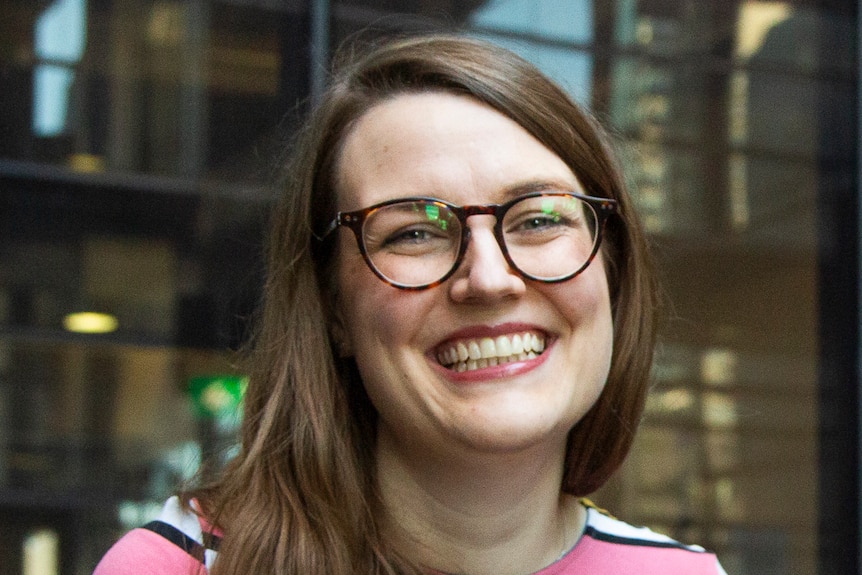 Young woman in glasses and colourful striped sweater