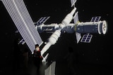 A giant screen shows images of China's Tianhe space station at an exhibition.