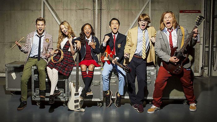 A teacher and students holding musical instruments