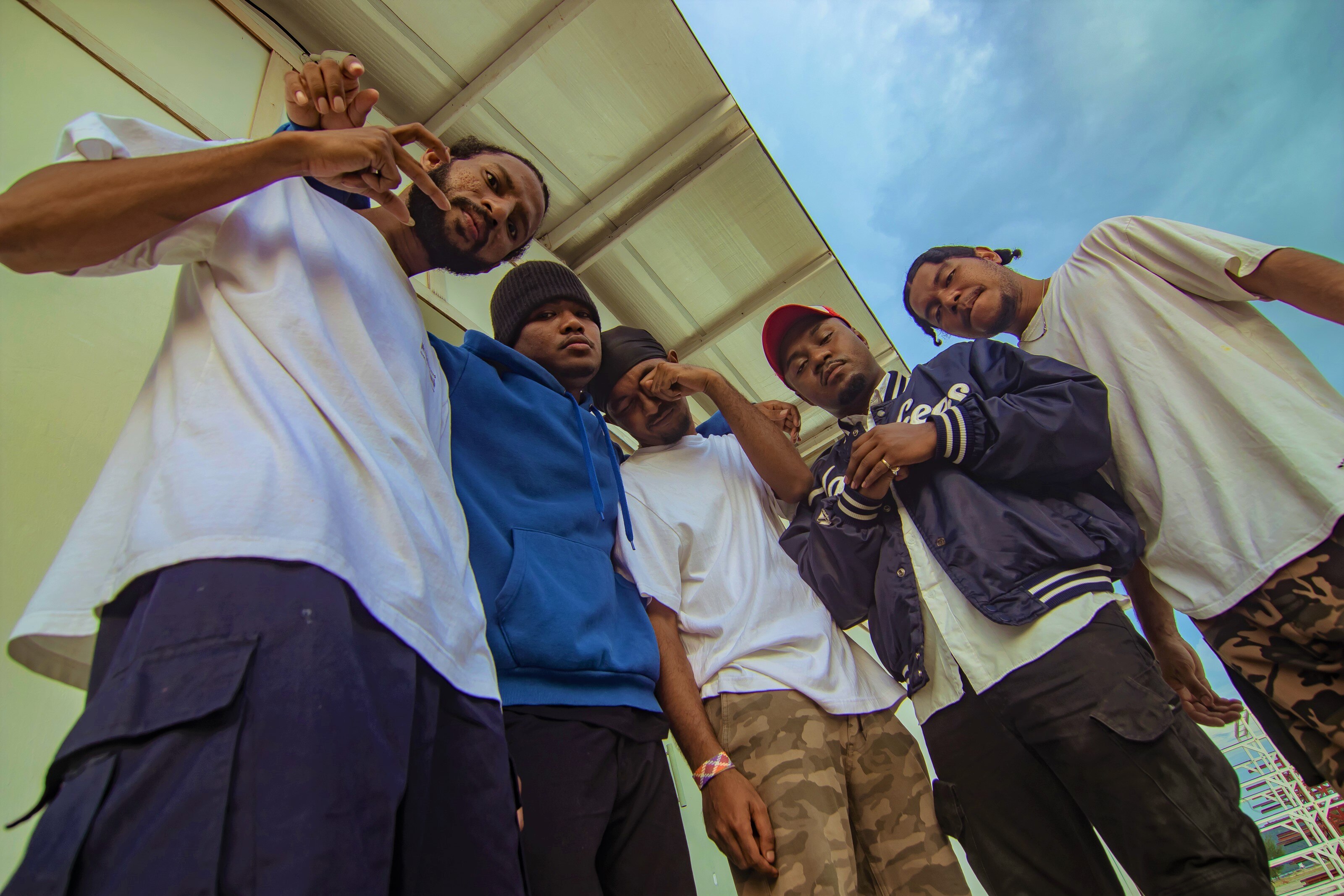 A group of six men looking at the camera with an angle from the ground