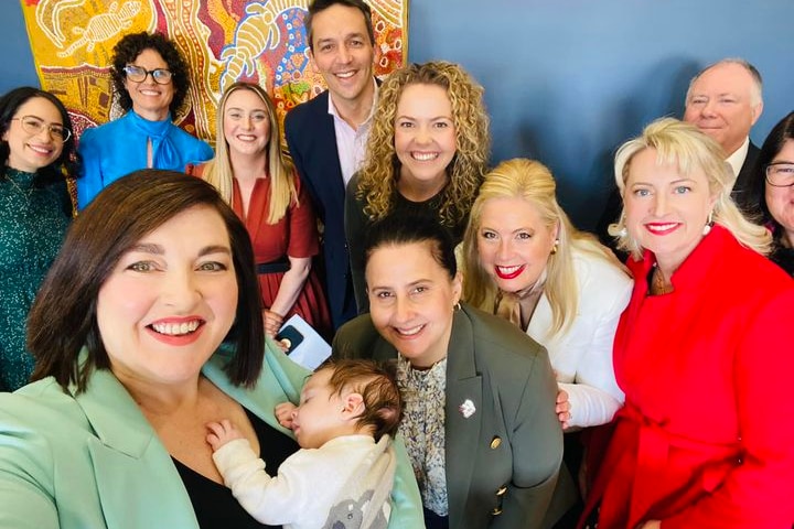 Jayne Stinson takes a selfie with her baby and a number of Labor MPs