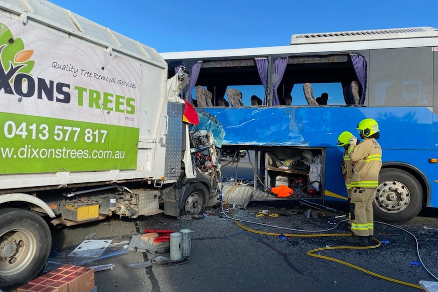 Emergency workers at the scene of a crash between a bus and a truck. 