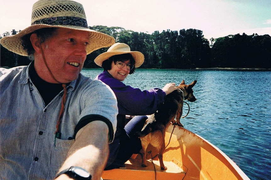 Judith McIntyre with her husband on a boat with a dog.