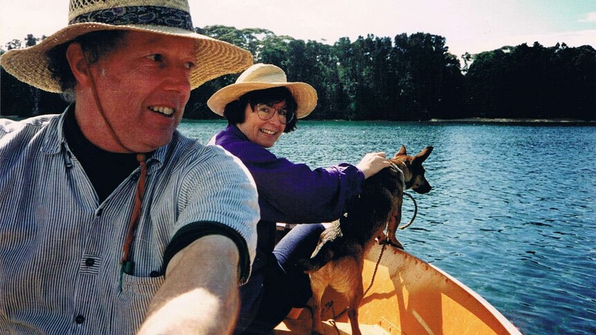 Judith McIntyre with her husband on a boat with a dog.