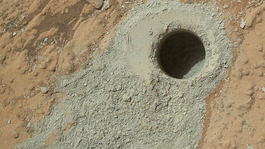 A hole and rock powder drilled by the Curiosity Rover.
