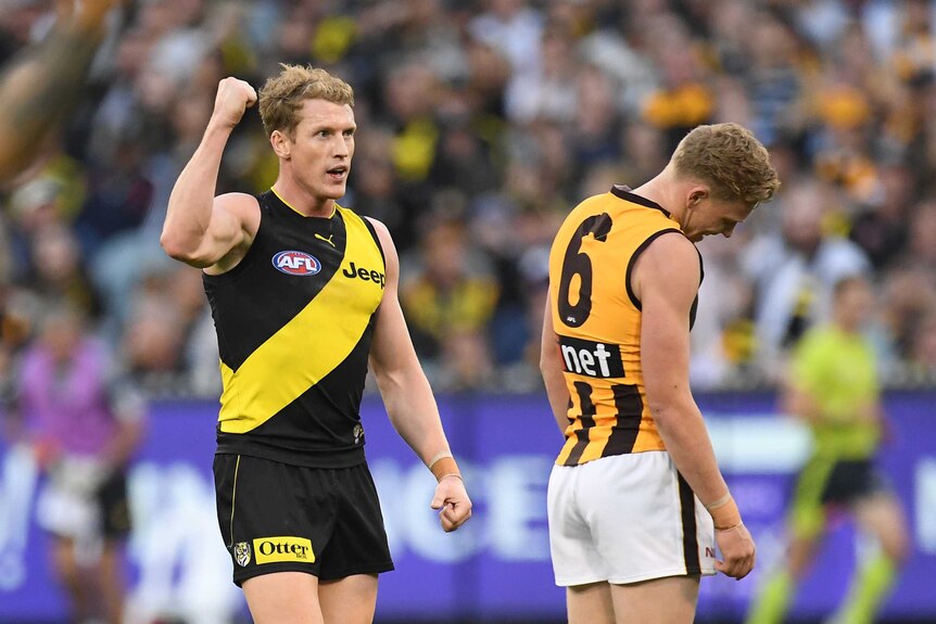 Josh Caddy pumps his right fist. Behind him, James Sicily bows his head in disappointment.