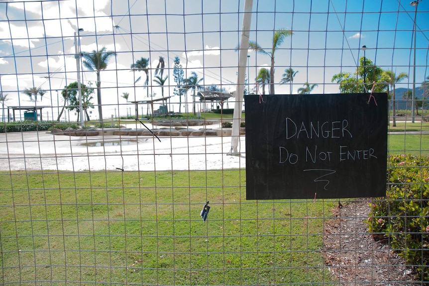 A sign shows the Airlie Beach lagoon is still under repair following Cyclone Debbie.