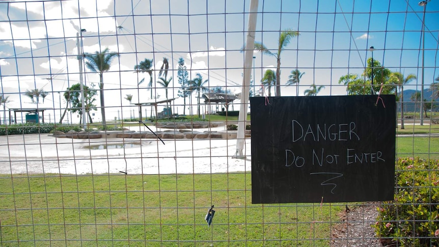 A sign shows the Airlie Beach lagoon is still under repair following Cyclone Debbie.