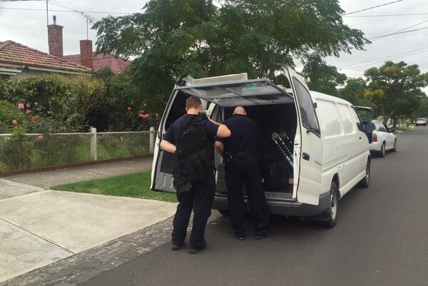 AFP officers outside Melbourne home after terror raids