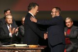 Colombia's President Juan Manuel Santos shakes hands with with FARC leader Rodrigo Londono.