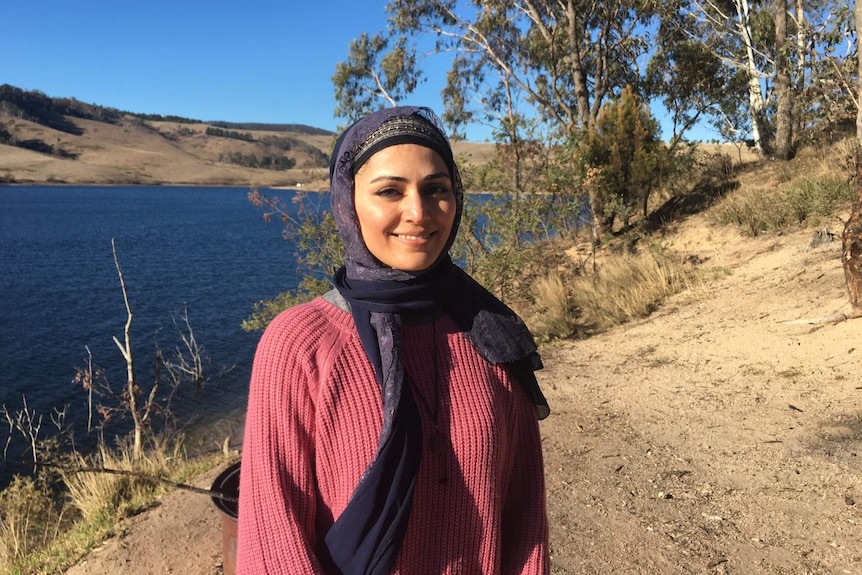 Mahsheed Ansari wearing hijab and standing in front of a lake.