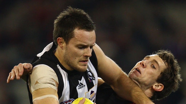 Nathan Brown shrugs off Kyle Hardingham as the Pies put Essendon to the sword.