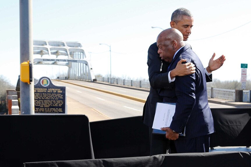 US president Barack Obama hugs Congressman John Lewis while on a stage at the end of the Edmund Pettus Bridge in Selma, Alabama.