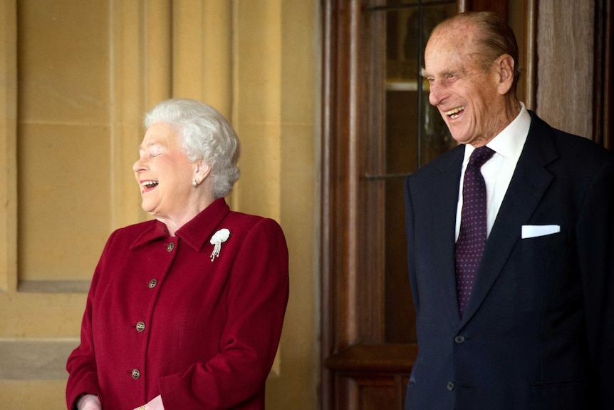 Britain's Queen Elizabeth and Prince Philip laugh after bidding farewell to the President of Ireland Michael D. Higgins and his wife Sabina at Windsor Castle in Windsor, southern England