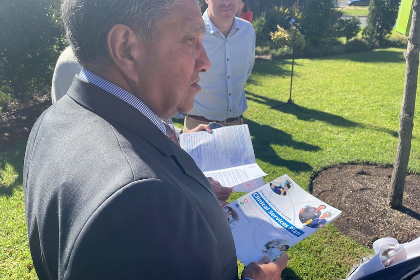 man in suit holding document