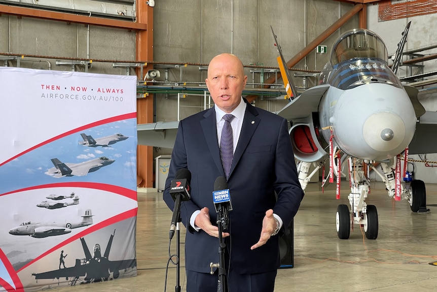 Mid shot of Defence Minister Peter Dutton speaking to the media at the RAAF Williamtown