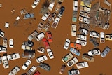 Wrecked cars sit in floodwaters