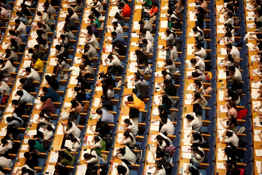 Rows of Chinese students at a testing facility taking entrance exams.
