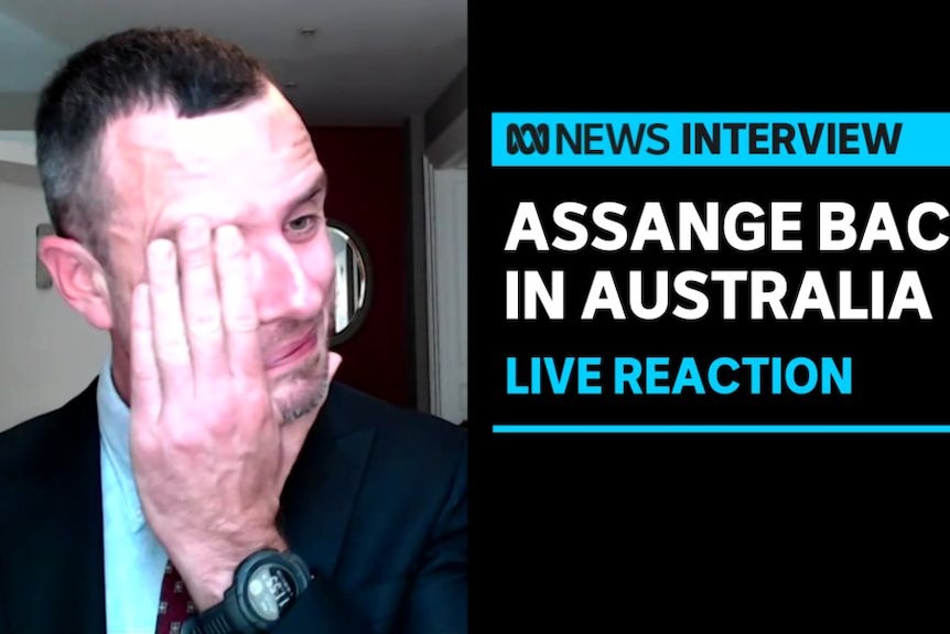 Assange Back in Australia, Live Reaction: A man wipes tears from his eyes during a television interview.