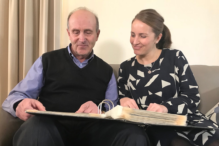 Meningcoccal disease victim Sarah Correy's father Brian Correy and best friend Emma McGrath look at a scrapbook of memories.