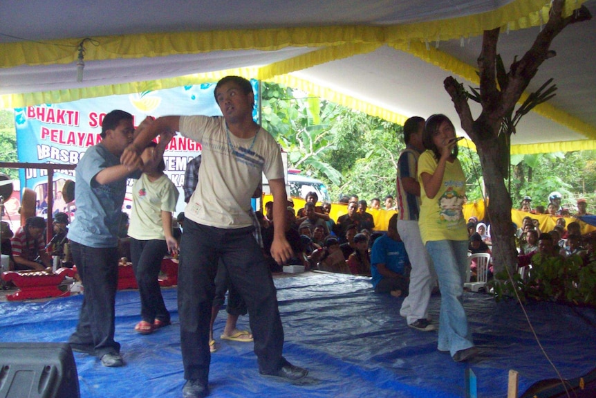 A group of people on a stage dancing to music