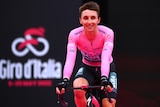 Jai Hindley is pictured in the pink Giro d'Italia leader's top as he crosses the finish line