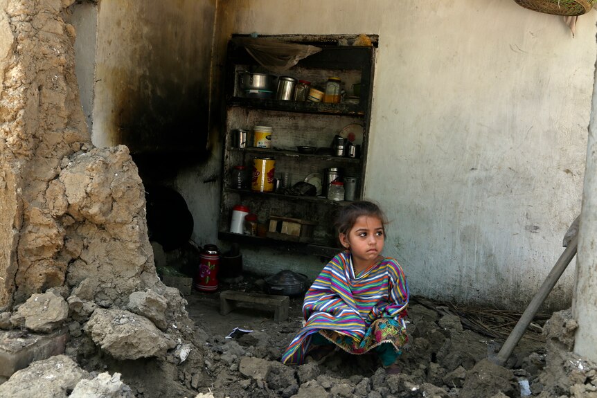 Pakistani girl in flood rubble