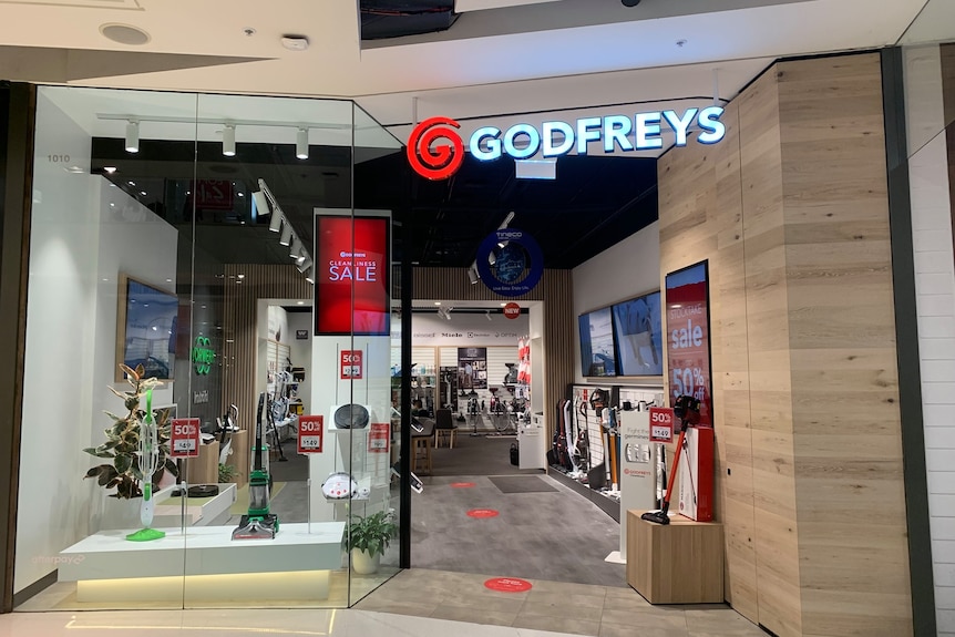 A photo of a retail store in a shopping centre selling vacuum cleaners.