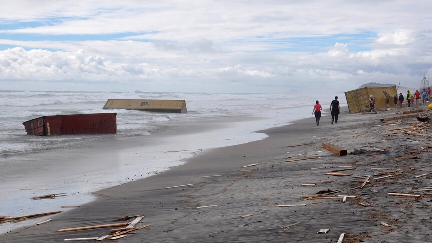 Shipping containers and debris from the container ship Rena wash up on Waihi Beach.