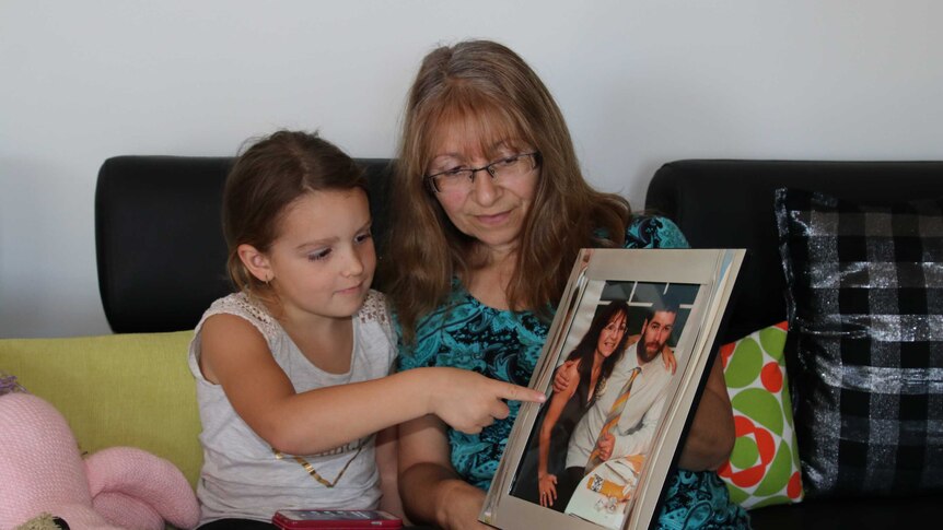 Angela Broadley and five-year-old granddaughter Charlotte looking at a photo of Joseph Da Silva.