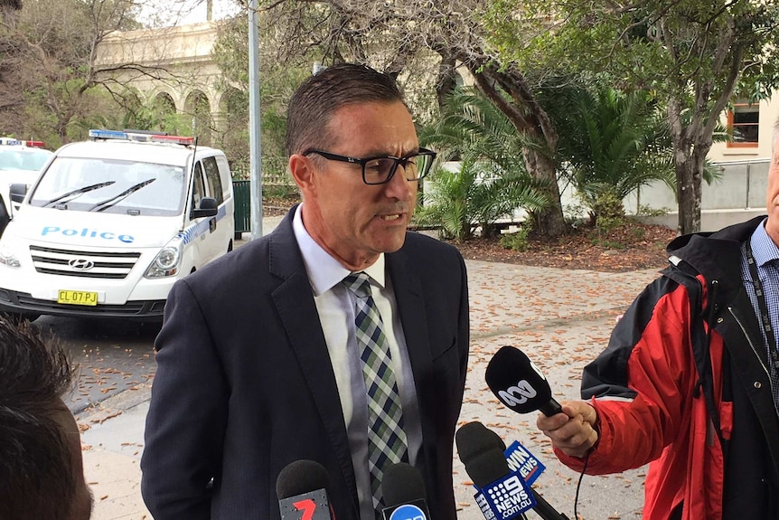 A police officer speaking to reporters