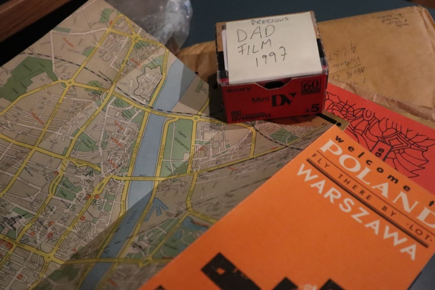 A box reads 'dad film 1997' and it sits among polish maps and books