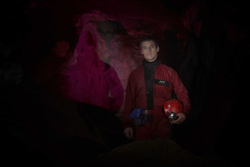A man stands in an underground cave