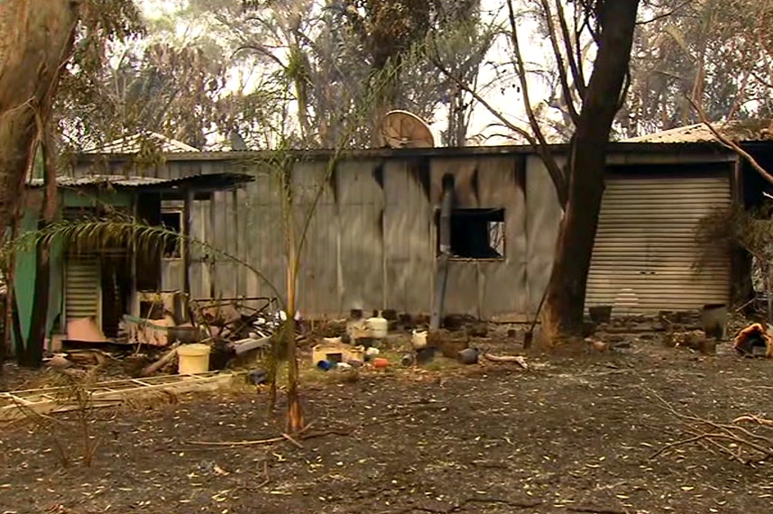 A photo of a burnt out shed or house in the Deepwater region.