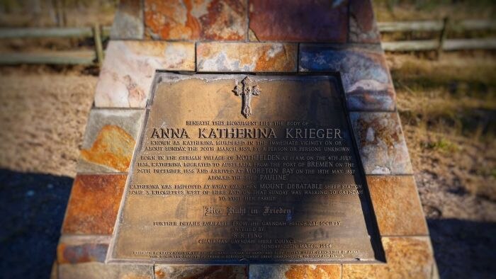 A slab of stone with a bronze-coloured plaque bearing the name Anna Katherina Krieger.