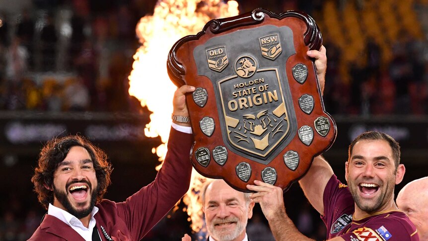 Johnathan Thurston and Cameron Smith of the Maroons lift the Origin shield.