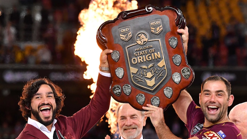 Johnathan Thurston and Cameron Smith of the Maroons lift the Origin shield.