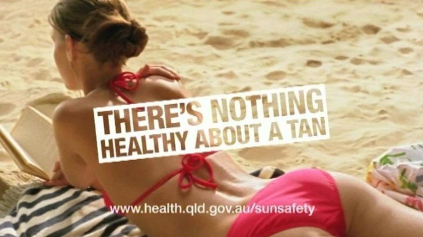 TV still of teen girl sunbathing from a new Qld Govt skin cancer advertisement warning.