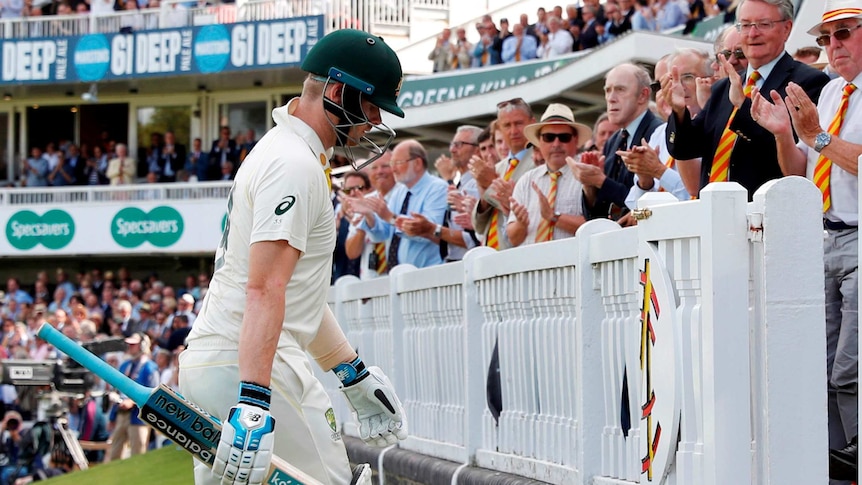 Steve Smith lowers his head as members of the crowd applaud him off at Lord's