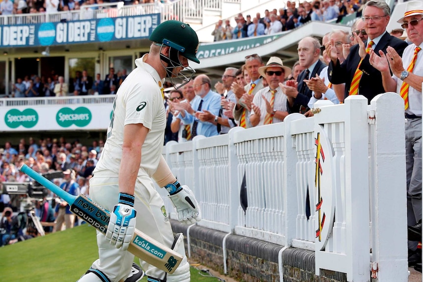 Steve Smith lowers his head as members of the crowd applaud him off at Lord's