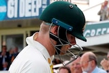 Steve Smith lowers his head as members of the crowd applaud him off at Lord's