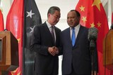 Chinese Foreign Minister Wang Yi (left) shakes hands with PNG's Foreign Minister Rimbink Pato.