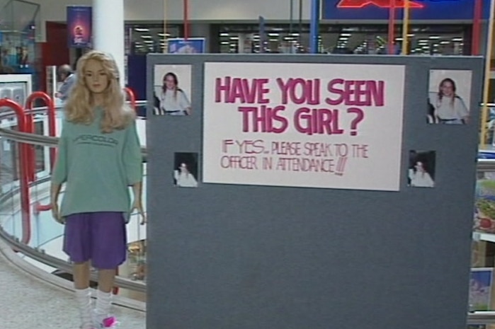 A mannequin with a blond wig and a missing person sign with pictures of Rhianna Barreau