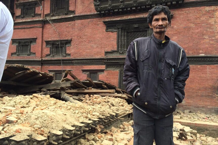 A man stands in Patan surrounded by bricks