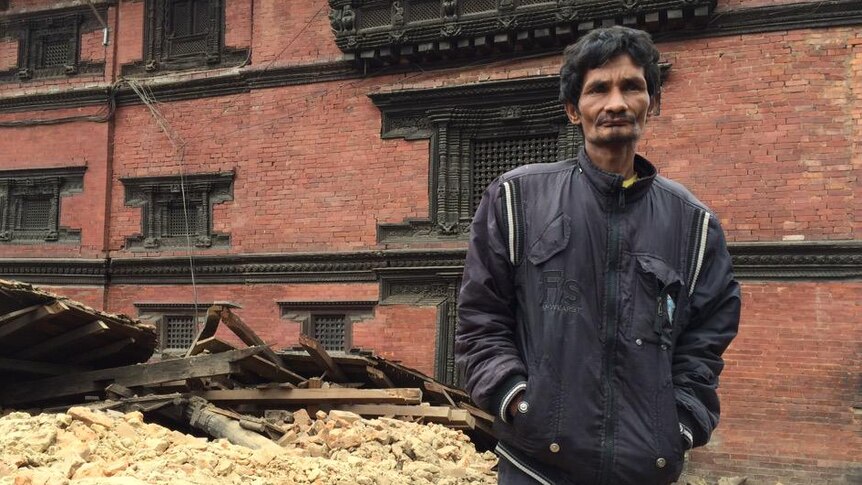 A man stands in Patan surrounded by bricks