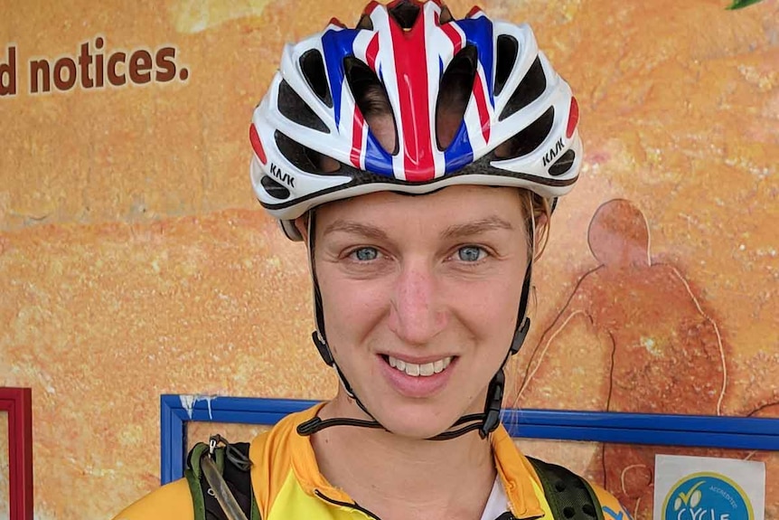 A close-up of a woman wearing a bike helmet.