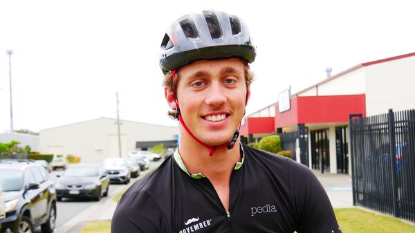 Portrait of a smiling young man wearing his cycle lycra and helmet