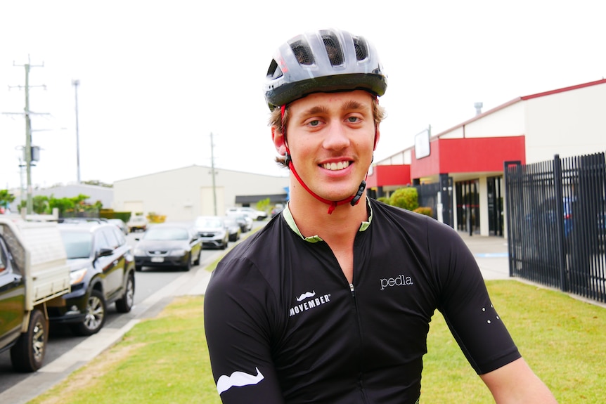 Portrait of a smiling young man wearing his cycle lycra and helmet 
