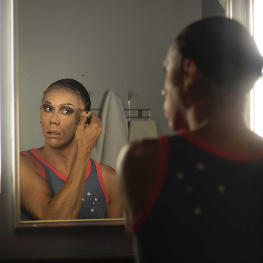 Drag queen John Ridgeway puts on make-up.