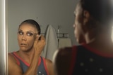 Drag queen John Ridgeway puts on make-up.